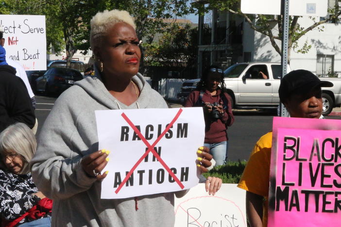 Kiora Hansen and Della Currie protest against racism by Antioch police officers at a rally in front of the police department on Tuesday.