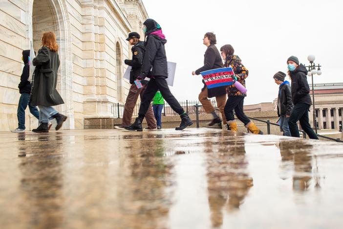 Activists and community members march into the Minnesota State Capitol building during a Trans Day of Visibility rally on March 31, 2023.