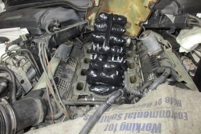 This Sept. 12, 2021 photo provided by the U.S. Customs and Border Protection shows drugs concealed inside the engine of a car.