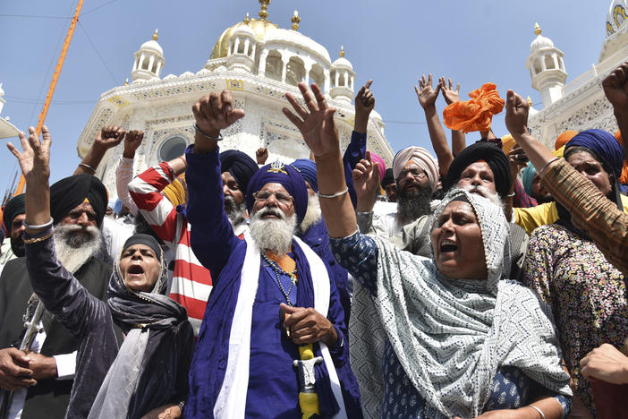 Supporters of Waris Punjab De organization shout slogans favoring their chief and separatist leader Amritpal Singh and other arrested activists during a meeting at the Akal Takht Secretariat inside Golden Temple complex, in Amritsar, India, on March 27, 2023.