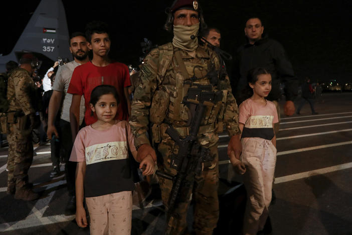 Jordanians evacuated from Sudan arrive at a military airport in Amman, Jordan, Monday, April 24, 2023.