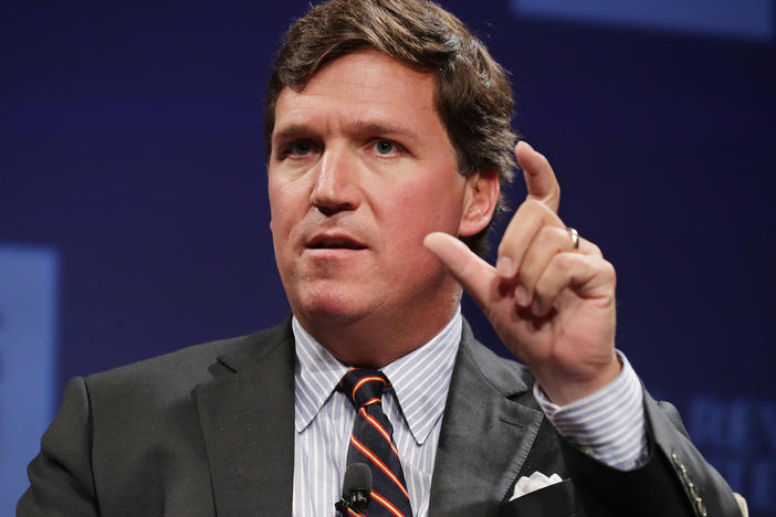 Fox News host Tucker Carlson speaks at a National Review Institute event on March 29, 2019, in Washington, D.C. The network announced Monday that it would "part ways" with Carlson.