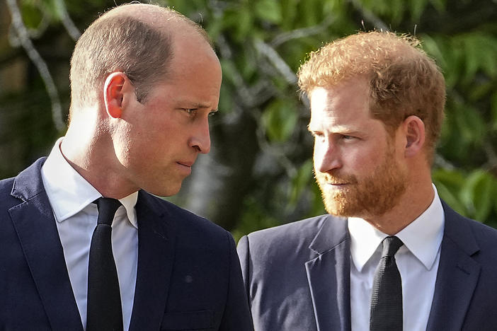 Prince William and Prince Harry walk after viewing tributes for the late Queen Elizabeth II outside Windsor Castle last September. Court papers say Prince William received "a very large sum of money" in a 2020 phone hacking settlement with the British newspaper arm of Rupert Murdoch's media empire. Prince Harry alleges in another lawsuit that Murdoch newspaper employees hacked into royals' phones.