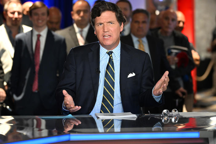 Tucker Carlson speaking at an event in Hollywood, Fla., in 2022. Carlson was ousted from Fox News on Monday. One of his legacies as a host will be mainstreaming conspiracy theories into politics and media.