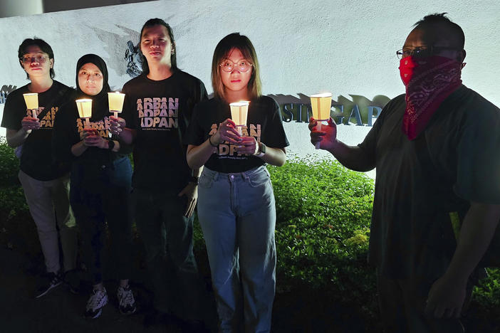 In this image taken and provided by Anti-Death Penalty Asia Network, members of Anti-Death Penalty Asia Network (ADPAN) hold candle outside Singapore Embassy in Kuala Lumpur, Malaysia Wednesday, April 26, 2023.