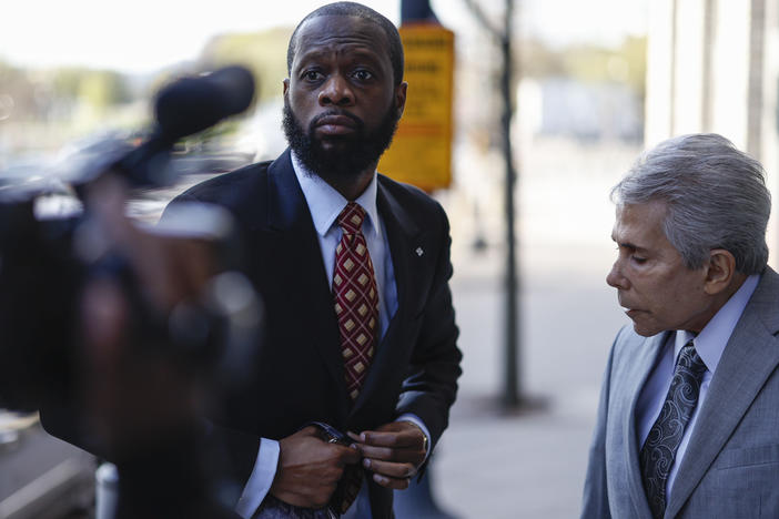 Pras Michel, former member of the Fugees, center, and his lawyer David Kenner arrive to federal court in Washington, D.C., on April 3, 2023.