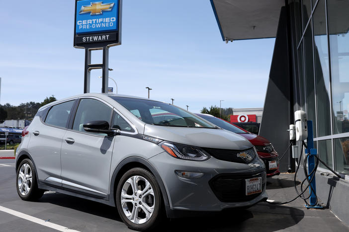 A Chevrolet Bolt EV is parked at a charging station at a dealer in Colma, Calif., on Tuesday.