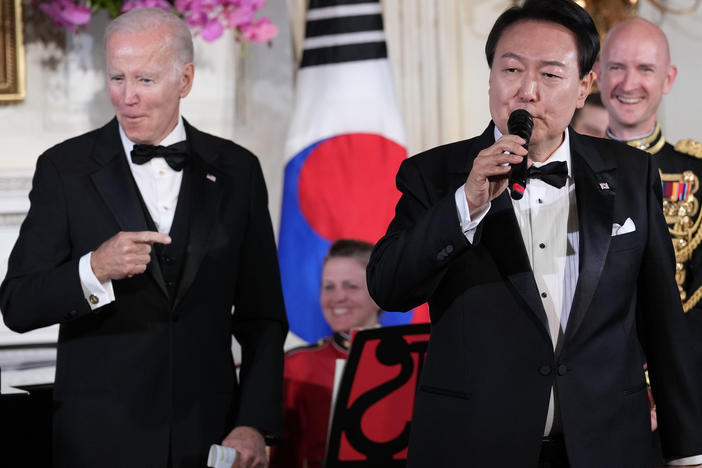 President Joe Biden reacts as South Korean President Yoon Suk Yeol sings the song "American Pie" in the State Dining Room of the White House on Wednesday.