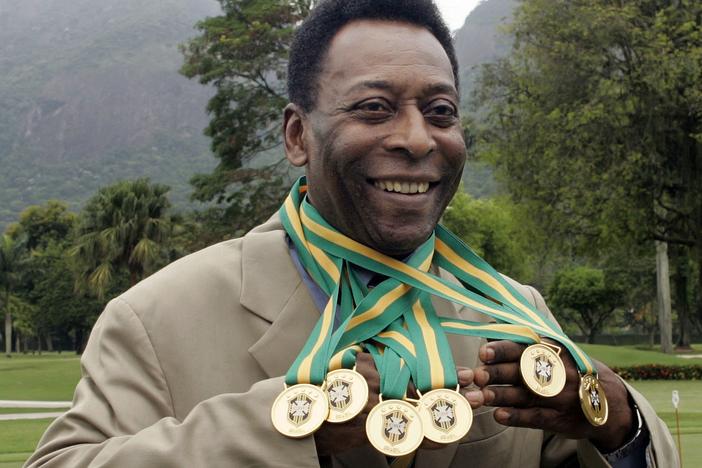 Brazilian football legend Edson Arantes do Nascimento, better known as Pelé, poses with his six Brazil's champion medals in 2010. A Portuguese language dictionary has recognized his name as a synonym for greatness.