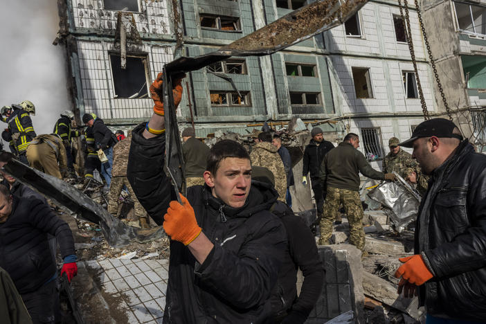 Following a Russian attack, first responders remove rubble at a residential building in Uman, central Ukraine on Friday.