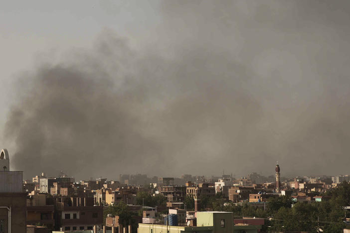 Smoke rises in Khartoum, Sudan, on Saturday, as gunfire and heavy artillery fire continued despite the extension of a ceasefire between the country's two top generals.