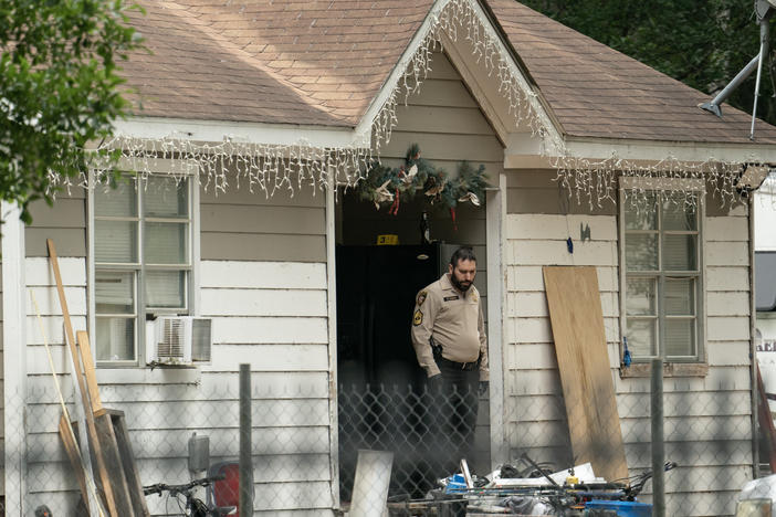 Law enforcement respond to a crime scene where five people, including an 8-year-old child, were killed after a shooting inside a home on Saturday in Cleveland, Texas.