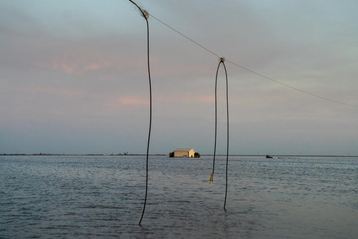 In California's Central Valley, a long-disappeared lake has been resurrected. A power line dangles precariously over the edge of the water now filling the Tulare Lake Basin, and a building on the horizon is caught in the middle of the flood.
