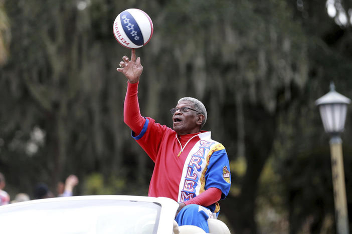 Larry "Gator" Rivers, a member of the Chatham County Commission and a former Harlem Globetrotter, shows off his ball handling skills as he rides in the annual Veterans Day Parade on Nov. 11, 2021 in Savannah, Ga.
