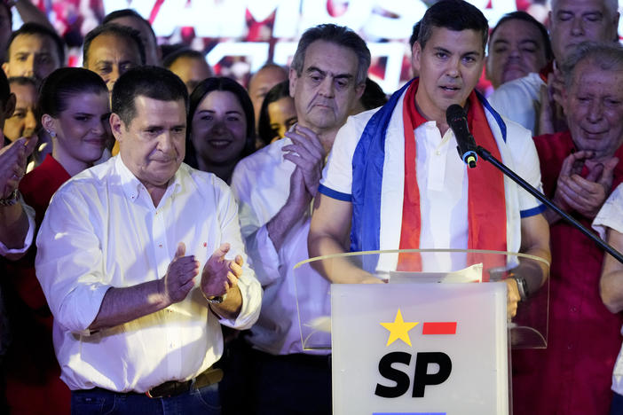 Santiago Peña, presidential candidate of the Colorado ruling party, right, talks beside former President Horacio Cartes after the voting closed during general elections in Asuncion, Paraguay, Sunday, April 30, 2023.