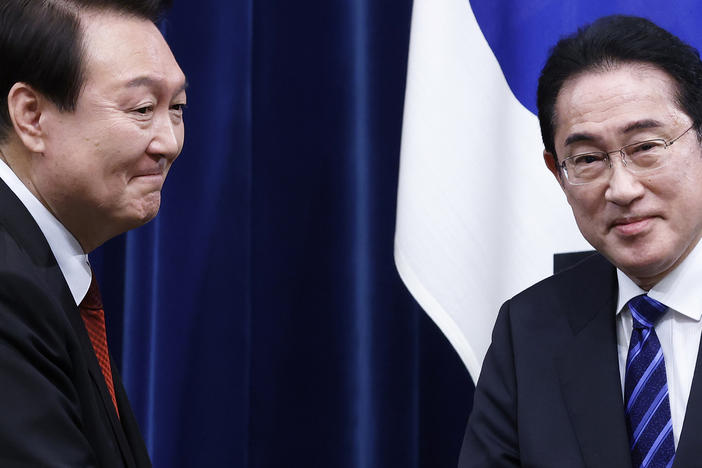 South Korean President Yoon Suk Yeol, left, and Japanese Prime Minister Fumio Kishida, right, shake hands following a joint news conference at the prime minister's office in Tokyo on March 16th.