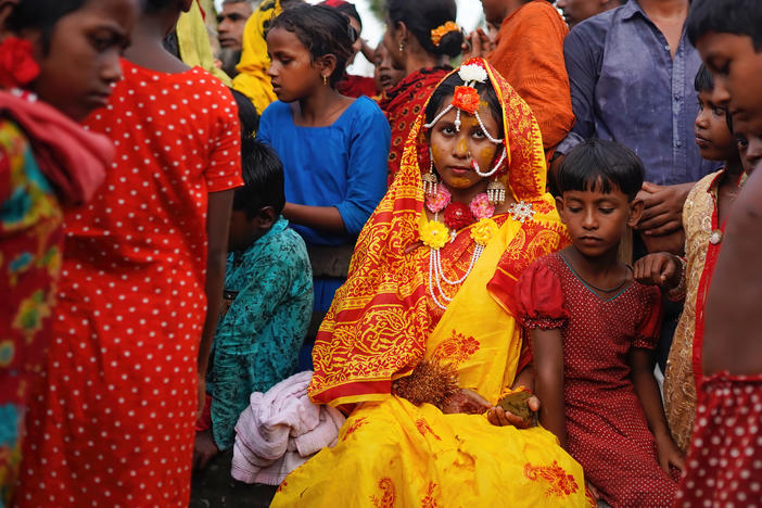 A 14-year-old schoolgirl in Bangladesh poses with friends and neighbors on her wedding day. A new UNESCO report looks at progress — and the lack thereof — in ending child marriage.