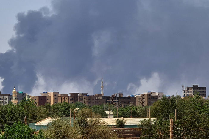 Smoke billows over buildings in Khartoum on May 1, 2023 as deadly clashes between rival generals' forces have entered their third week.