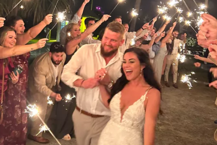 Aric Hutchinson and Samantha Miller are pictured at their wedding on Friday in a photo on a GoFundMe page. They were traveling in a golf cart hours later when a driver struck, killing Miller and injuring Hutchinson and two others.