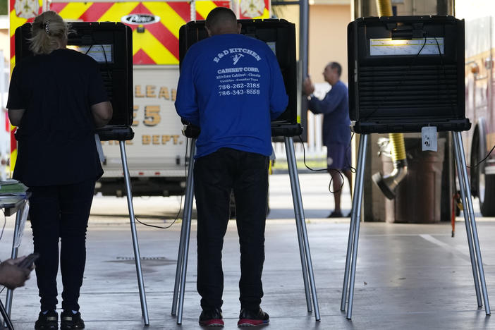 People vote in the midterm elections on Nov. 8, 2022, at a fire station in Hialeah, Fla.