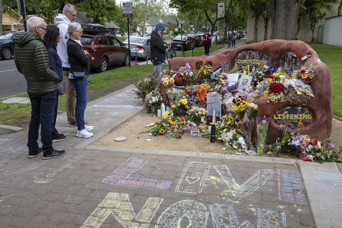 People view a memorial set up at the compassion bench in Davis, Calif., on Monday, May 1, 2023, to honor David Henry Breaux, 50 years old, who was found stabbed to death in Central Park.