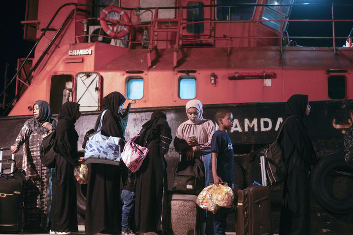 Sudanese evacuees wait before boarding a Saudi military ship to Jeddah port, at Port Sudan in Sudan, Wednesday, May 3, 2023. Many are fleeing the conflict in Sudan between the military and a rival paramilitary force.