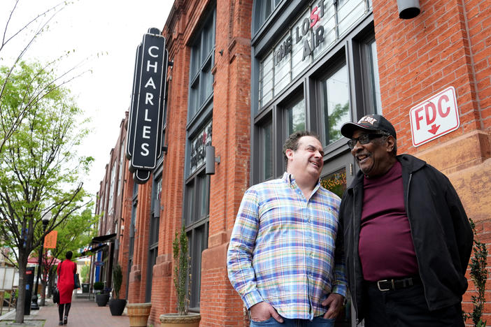 Record producer Zev Feldman (left) and John Fowler, a charter member of the Left Bank Jazz Society, meet outside the Charles Theater in downtown Baltimore. The building once hosted some of the best jazz musicians in the country.