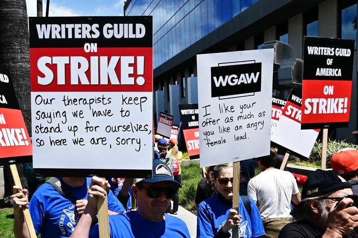 Writers picket in front of Netflix offices in Hollywood on Tuesday as the WGA strike began.