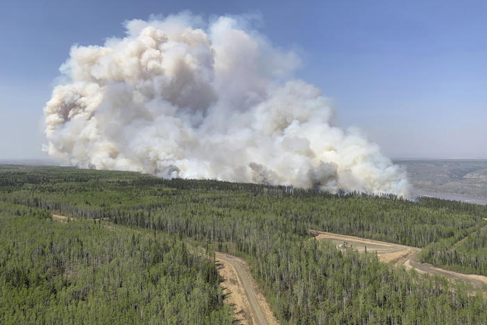 A wildfire burns a section of forest in the Grande Prairie district of Alberta, Canada, on Saturday.