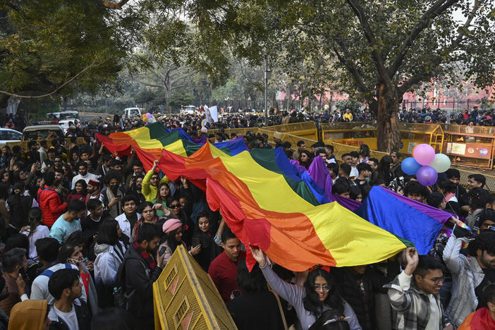 Members of the LGBTQ+ community and their supporters carry a rainbow flag as they march demanding equal marriage rights in New Delhi, India, in January. The Supreme Court in 2018 struck down a colonial-era law that made gay sex punishable by up to 10 years in prison, and is now hearing arguments in a case to legalize same-sex marriage.