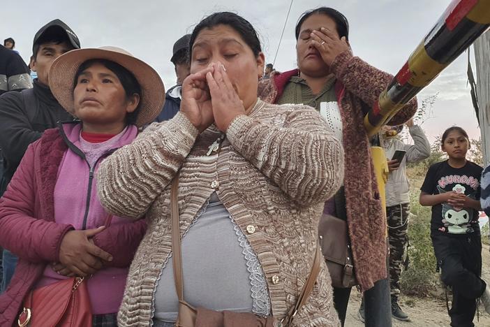 Relatives of trapped miners wait outside the SERMIGOLD mine in Arequipa, Peru, Sunday, May 7, 2023. The Public Ministry confirmed the death of 27 miners, who were trapped early Saturday morning due to an explosion in a tunnel inside the artisanal mine located in Yanaquihua district in Arequipa.
