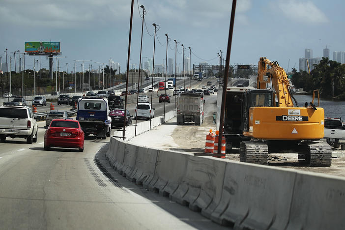 Construction workers build along State Road 836 in 2018 in Miami. HB 1191 would compel the Florida Transportation Department to study using phosphogypsum in paving projects.