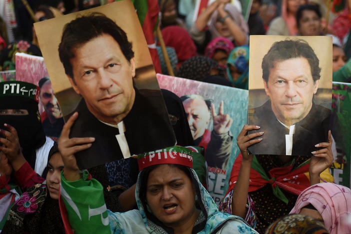 Supporters carry placards displaying a portrait of Imran Khan during a protest in Karachi on March 19, demanding release of arrested party workers in recent police clashes.