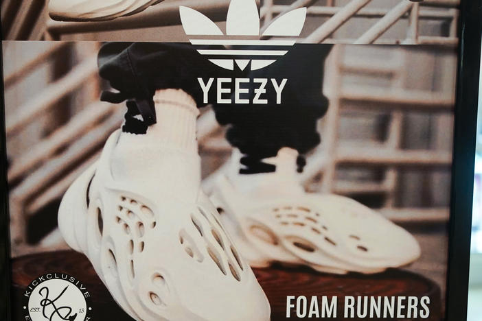 A sign advertises Yeezy shoes made by Adidas at a store in Paramus, N.J., on Oct. 25, 2022. After cutting ties with Ye, formerly known as Kanye West, Adidas now plans to sell its stock of unsold Yeezy shoes and donate the proceeds to charity.