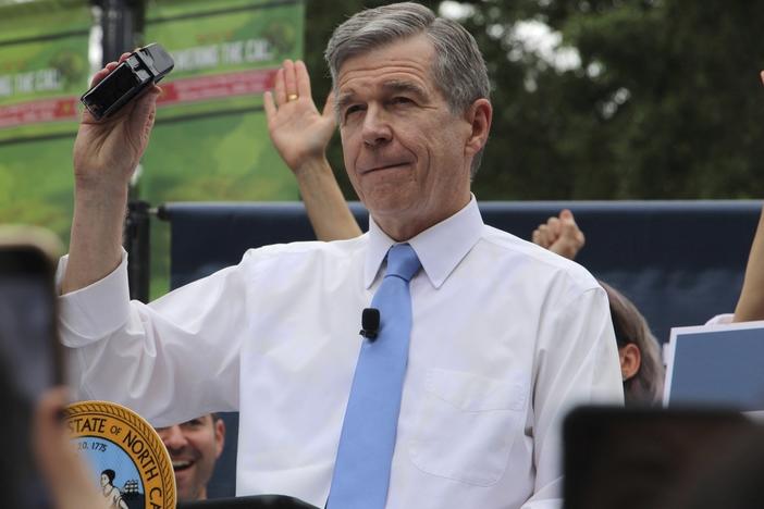 North Carolina Democratic Gov. Roy Cooper affixes his veto stamp to a bill banning nearly all abortions after 12 weeks of pregnancy at a public rally on Saturday in Raleigh, N.C.