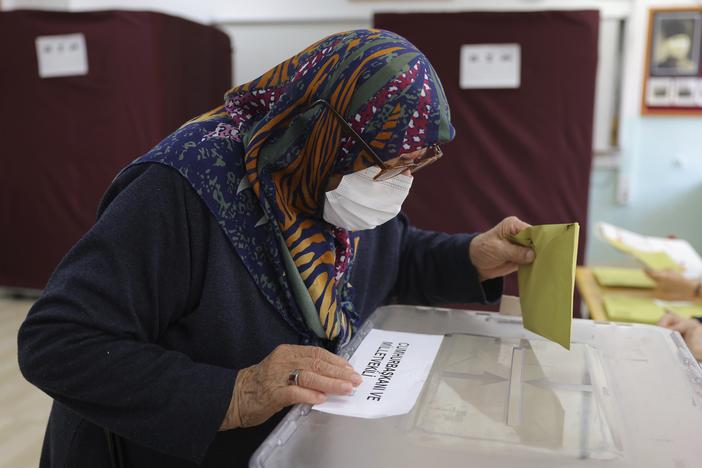 A woman votes at a polling station in Ankara, Turkey, Sunday, May 14, 2023. Voters in Turkey go to the polls on Sunday for pivotal parliamentary and presidential elections that are expected to be tightly contested and could be the biggest challenge Turkish President Recep Tayyip Erdogan faces in his two decades in power.