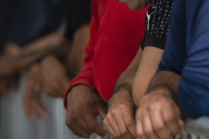 Migrants wait at the Gateway International port of entry under U.S. Customs and Border Protection custody in Brownsville, Texas, on May 5, before being sent back to Mexico under then-active Title 42 restrictions.