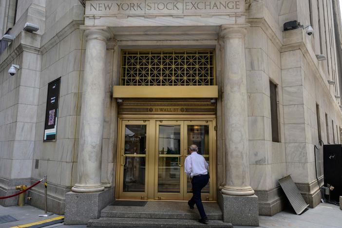 A man enters the New York Stock Exchange on Wall Street in New York City on Friday.