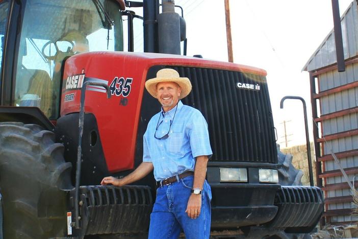 Arizona farmer Craig Alameda stands next to a tractor on his farm near Yuma.