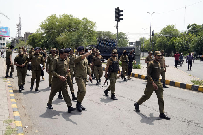 Police officers patrol around the residence of Pakistan's former Prime Minister Imran Khan, in Lahore, Pakistan, Thursday. Pakistani police kept up their siege around the home of Khan as a 24-hour deadline given to the former premier to hand over suspects allegedly sheltered inside was about to expire on Thursday.