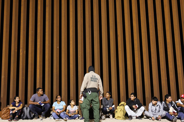 A border patrol agent speaks to people who were apprehended in Yuma, Arizona on May 11 a the U.S. border as Title 42 expired. The agency said on Wednesday that an 8-year-old girl died after being detained.