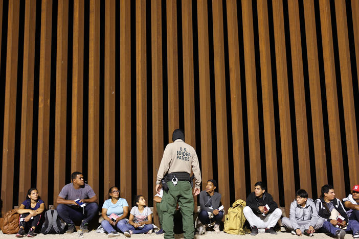 A border patrol agent speaks to people who were apprehended in Yuma, Arizona on May 11 a the U.S. border as Title 42 expired. The agency said on Wednesday that an 8-year-old girl died after being detained.