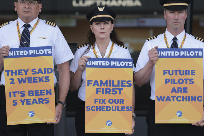 United Airlines pilots participate in a picket line at Washington Dulles International Airport on May 12, 2023. Ahead of a busy summer travel season, they're asking for higher wages and also quality of life improvements.