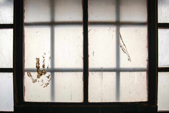 A handprint stained on the window at the Navajo Nation Detention in Shiprock, N.M., on April 13, 2021.