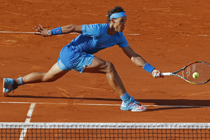 Spain's Rafael Nadal plays a shot in the fourth round match of the French Open tennis tournament against Jack Sock of the U.S. to win in four sets 6-3, 6-1, 5-7, 6-2, at the Roland Garros stadium, in Paris, France, Monday, June 1, 2015.