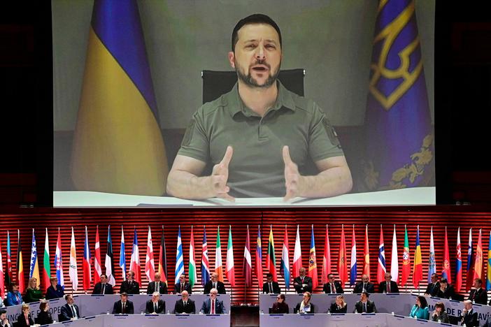 Ukraine's President Volodymyr Zelenskyy appears on screen to speak at the opening of the 4th Summit of the Heads of State and Government of the Council of Europe on May 16, 2023. Ukraine announced on Friday that Zelenskyy will travel to Japan this weekend to attend the Group of Seven leading industrial nations' summit.