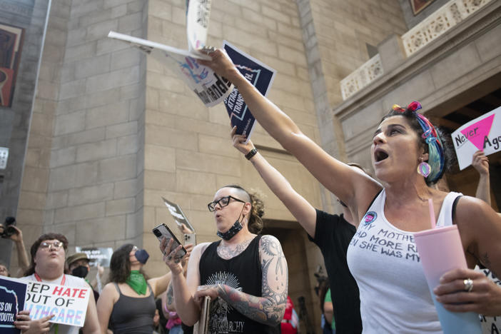 Juju Tyner of Lincoln, right, leads the singing of "Over the Rainbow" during the protest of LB 574, which limits gender-affirming care for trans youth, on Friday, May 19, 2023, in Lincoln, Neb.