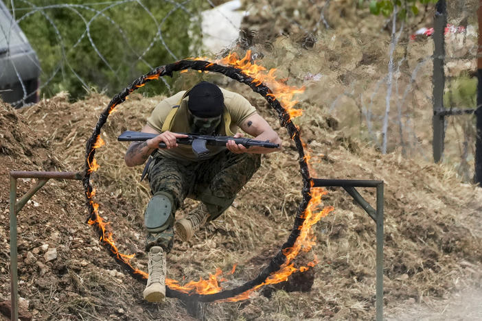 A Fighter from the Lebanese militant group Hezbollah carries out a training exercise in Aaramta village in the Jezzine District, southern Lebanon, on Sunday.
