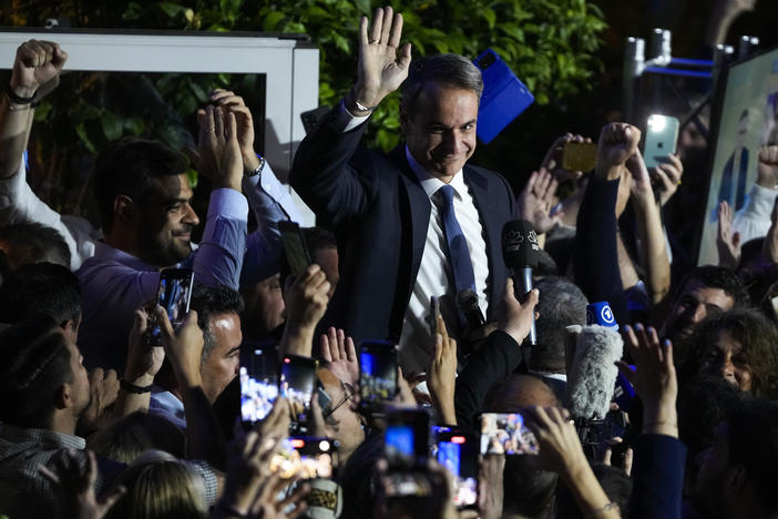 Greece's Prime Minister and leader of New Democracy Kyriakos Mitsotakis, center, addresses supporters at the headquarters of his party in Athens, Greece, Sunday, May 21, 2023.
