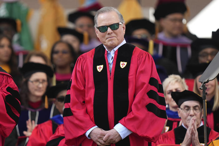 Warner Bros. Discovery CEO David Zaslav stands onstage while being introduced before delivering a commencement address at Boston University, Sunday, May 21, 2023, in Boston.